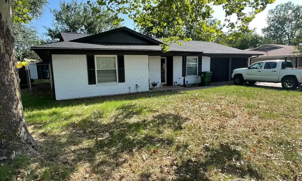 Professional roofing crew working on a residential roof in Alexandria